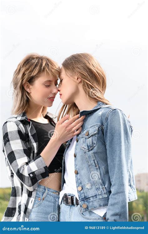 Authentic LGBT female lesbian couple kissing each other in slow。